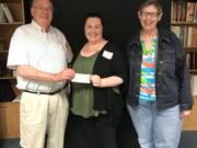 Esther Short: Southwest Washington School Retirees Organization treasurer Marty Erickson, from left, Cassie Sorensen, of the Homestead shelter, and Jody Bugg, co-president of the retirees organization, which donated $500 to Sorensen’s literacy room project at the shelter.