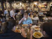 Jerry Roulette of Vancouver, center in blue, eats breakfast with his family at the new Cracker Barrel Old Country Store in Jantzen Beach on Monday morning. Cracker Barrel has more than 650 locations nationwide.