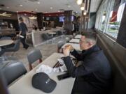 Vancouver resident Daniel O’Connell relaxes in a booth on his lunch break at the McDonald’s at 2814 N.E. Andresen Road in Vancouver, which is one of several local restaurants that has been upgraded to provide casual relaxation for diners.