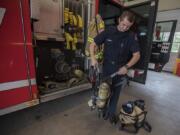 Intern firefighter Joel Vanness displays a self-contained breathing apparatus that firefighters use at East County Fire and Rescue in rural east Clark County. An increase in call volume and property values are stretching East County Fire and Rescue’s budget and the department is thinking about asking to put a levy lid lift up for vote just to maintain service. The chief said that if the vote passes, they might look to replace the air packs firefighters use when entering a burning structure and the jaws of life on some engines.