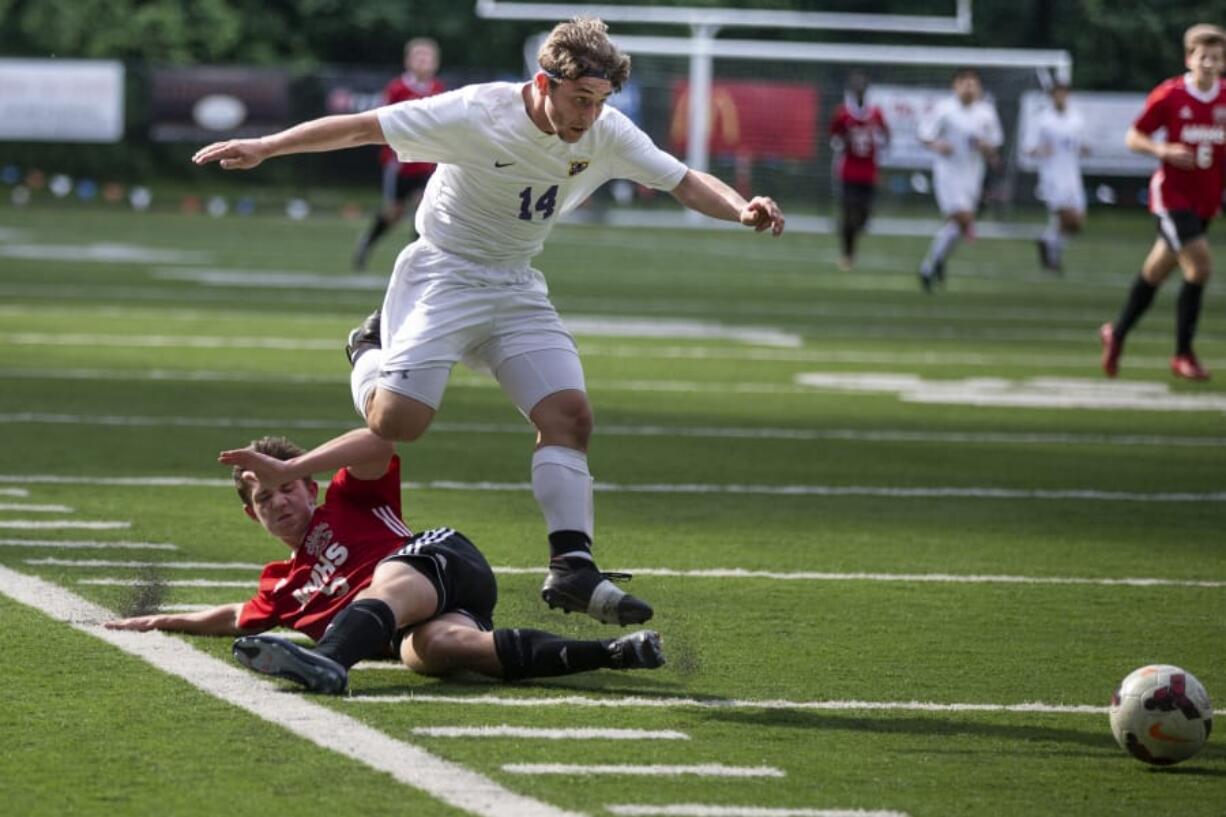 Columbia River Chieftans Jake Connop (14) leaps over an Archbishop Murphy player in the first half of the quarterfinals of Class 2A state high school soccer playoffs on May 19, 2017 at Kiggins Bowl in Vancouver. (Randy L.