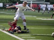 Columbia River Chieftans Jake Connop (14) leaps over an Archbishop Murphy player in the first half of the quarterfinals of Class 2A state high school soccer playoffs on May 19, 2017 at Kiggins Bowl in Vancouver. (Randy L.