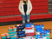 Washougal: Washougal High School senior Hannah Raynor with some of the shoes she collected for her senior project, in which she purchased sneakers and socks for students at Hathaway Elementary School.