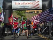 Amanda Cowan/The Columbian Participants in the Race to Remember 5K and 10K races take off from the starting line at Veterans of Foreign Wars Memorial Plaza on Monday morning.