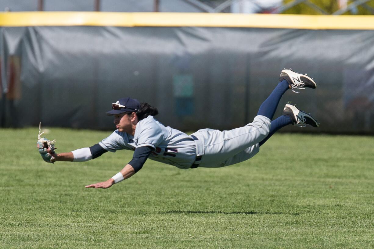 King's Way Christian center fielder Sam Lauderdale makes a diving catch in the fourth inning of the Knights' 4-2 win over Montesano in the District 4 title game Saturday at Castle Rock.