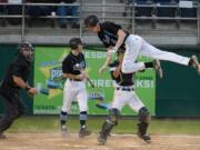 Freeman's Michael Coumont is tagged out by King's Way Christian catcher Hunter Aarhus during the sixth inning of the Class 1A state championship baseball game Saturday in Yakima.