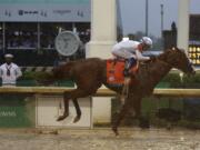 Mike Smith rides Justify to victory during the 144th running of the Kentucky Derby horse race at Churchill Downs Saturday, May 5, 2018, in Louisville, Ky.