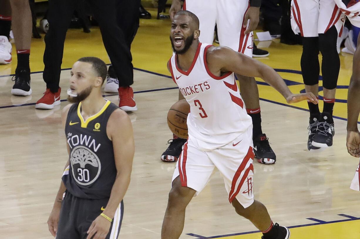 Houston Rockets guard Chris Paul (3) celebrates next to Golden State Warriors guard Stephen Curry (30) during the second half of Game 4 of the NBA basketball Western Conference Finals in Oakland, Calif., Tuesday, May 22, 2018.