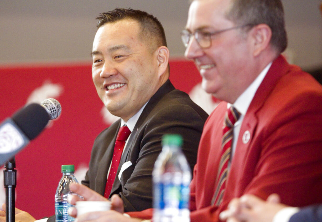 FILE - In this Jan. 23, 2018, file photo Washington State University President Kirk Schulz, right, and the university's new athletic director, Patrick Chun, answer questions during a press conference in Pullman, Wash. Chun is presenting a plan the school says will eventually tackle an athletics department budget deficit expected to grow to more than $85 million.