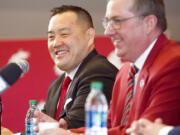 FILE - In this Jan. 23, 2018, file photo Washington State University President Kirk Schulz, right, and the university's new athletic director, Patrick Chun, answer questions during a press conference in Pullman, Wash. Chun is presenting a plan the school says will eventually tackle an athletics department budget deficit expected to grow to more than $85 million.