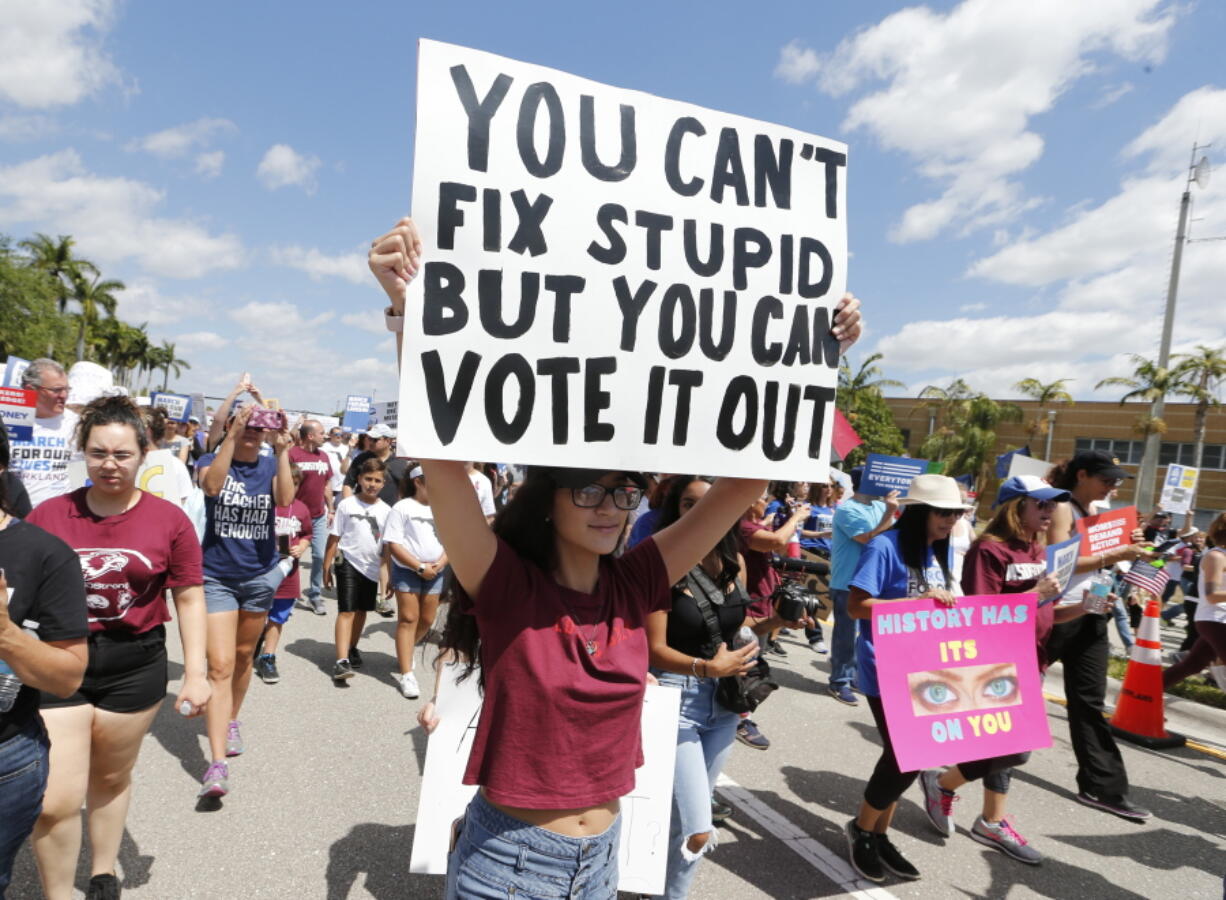 People take part in a “March For Our Lives” rally March 24 in Parkland, Fla. TA new poll from The Associated Press-NORC Center for Public Affairs Research and MTV reveals a significant surge in the number of young people who feel politically empowered, a change that comes after a school shooting in Florida elevated the voices of high school students in American politics.