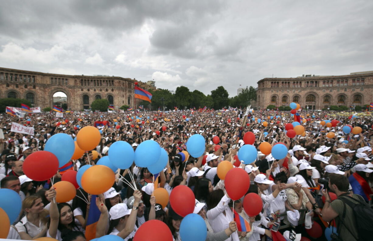 People cheer in Republic Square in Yerevan, Armenia, Tuesday, May 8, 2018. Tens of thousands of supporters of Nikol Pashinian are celebrating on the central square of Armenia’s capital after the protest leader was elected the country’s prime minister. Many of the supporters are wearing white clothes, symbolizing their hopes that Pashinian’s election will bring a new page in Armenia.