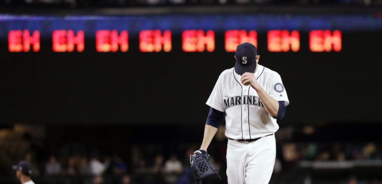 Seattle Mariners starting pitcher James Paxton gets ready for the next batter after striking out an Oakland Athletics player as a line of “eh’s,” a nod to Paxton’s Canadian heritage and his strikeout count, appears on a scoreboard during the seventh inning of a baseball game Wednesday, May 2, 2018, in Seattle.