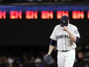 Seattle Mariners starting pitcher James Paxton gets ready for the next batter after striking out an Oakland Athletics player as a line of “eh’s,” a nod to Paxton’s Canadian heritage and his strikeout count, appears on a scoreboard during the seventh inning of a baseball game Wednesday, May 2, 2018, in Seattle.