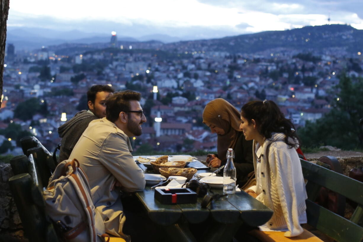 A group of people break their fast on the first day of the fasting month of Ramadan, on an old fortress overlooking the historic center of Sarajevo, Bosnia, on Wednesday. Muslim Bosniaks make up around 40 percent of Bosnia’s population of 3.8 million. Many of them celebrate Muslim holy month of fasting during which they abstain from food, drink and smoking from sunrise to sunset.