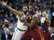 Cleveland Cavaliers forward LeBron James, right, fights for position against Boston Celtics forward Marcus Morris (13) during the third quarter of Game 1 of the NBA basketball Eastern Conference Finals, Sunday, May 13, 2018, in Boston.