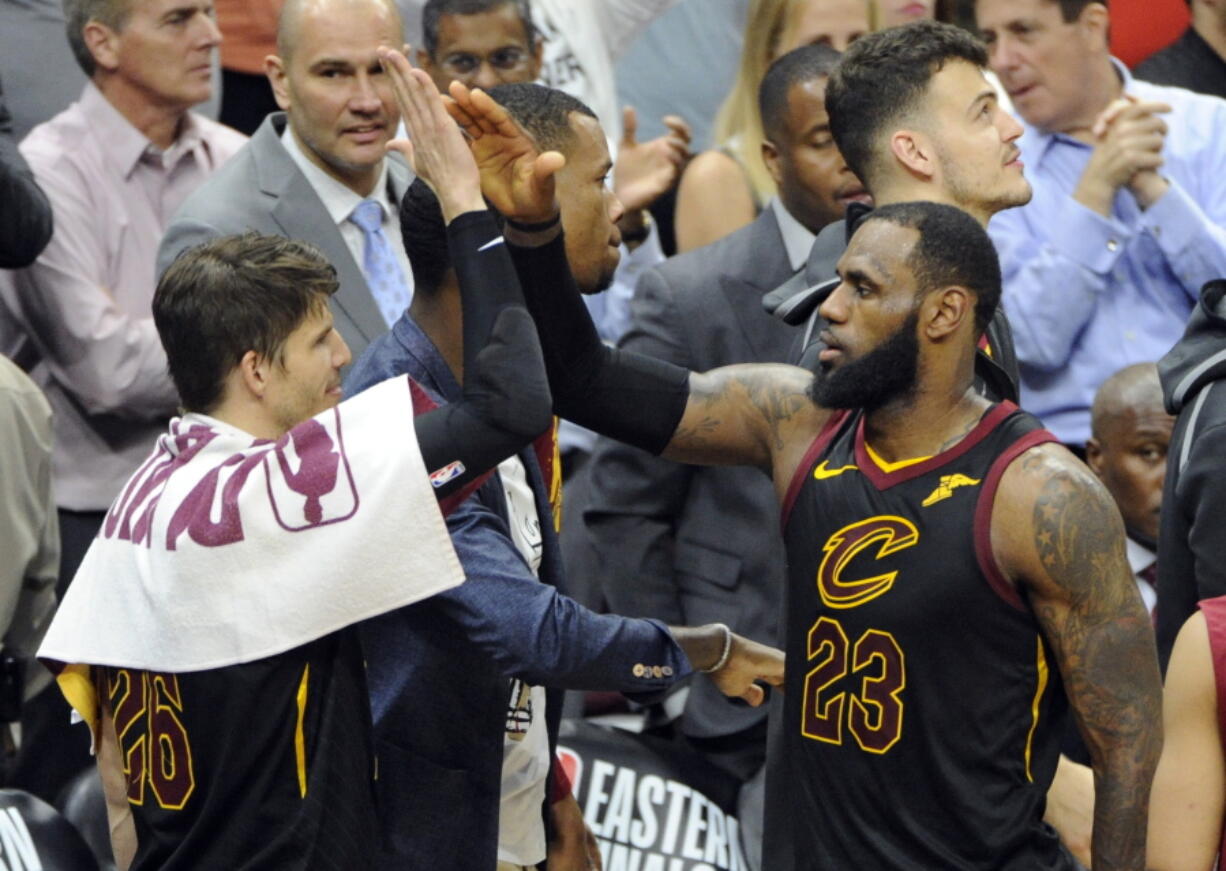 Cleveland Cavaliers' LeBron James, right, is congratulated by Kyle Korver in the second half of Game 6 of the NBA basketball Eastern Conference finals, Friday, May 25, 2018, in Cleveland.