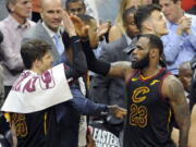 Cleveland Cavaliers' LeBron James, right, is congratulated by Kyle Korver in the second half of Game 6 of the NBA basketball Eastern Conference finals, Friday, May 25, 2018, in Cleveland.