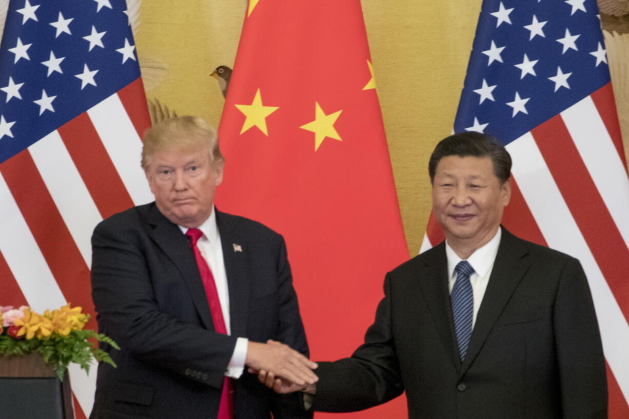 FILE - In this Nov. 9, 2017 file photo, President Donald Trump and Chinese President Xi Jinping shake hands during a joint statement to members of the media Great Hall of the People in Beijing, China. The U.S. is announcing that it will impose a 25 percent tariff on $50 billion worth of Chinese goods containing “industrially significant technology.” The White House said Tuesday, May 29, 2018, that the tariff will cover goods related to the “Made in China 2025” program. The full list of imports that will be covered will be announced by June 15.