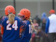 Ridgefield players and sisters Kaia Oliver and Karli Oliver chat before an at-bat in the Spudders' 4-3 extra innings loss the 2A district softball finals at Fort Borst Park in Centralia on Friday, May 18, 2018 (Andy Buhler/Columbian staff).