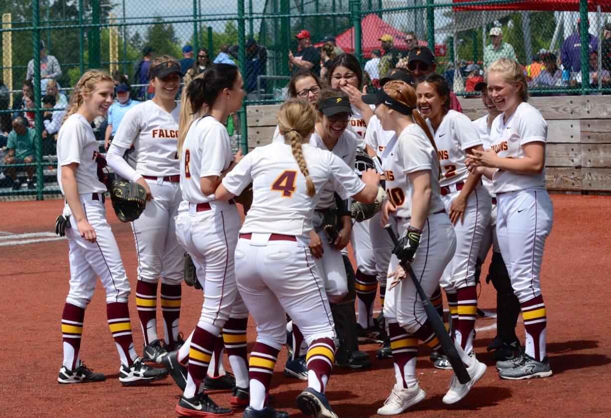 Prairie softball shortstop Clarissa Martinez (4) riles up her teammates in between innings of Prairie's 6-2 loss to Marysville-Pilchuck in the first round of the state tournament at the Regional Athletic Complex in Lacey on Friday, May 25, 2018.