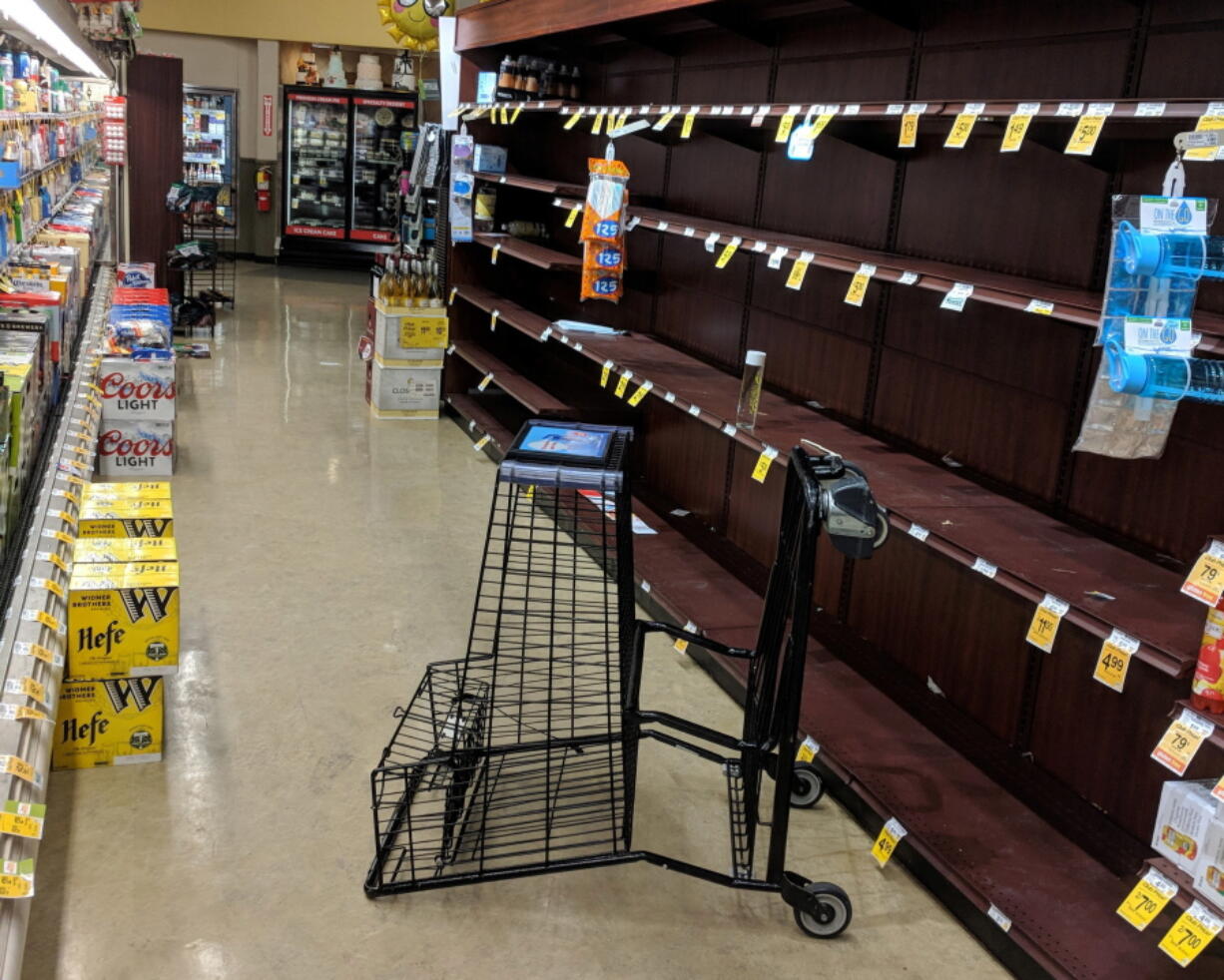 Supermarket shelves are stripped of bottled water late Tuesday in Salem, Ore., after officials warned residents that tap water was unsafe for kids and those with compromised immune systems due to an algae bloom.