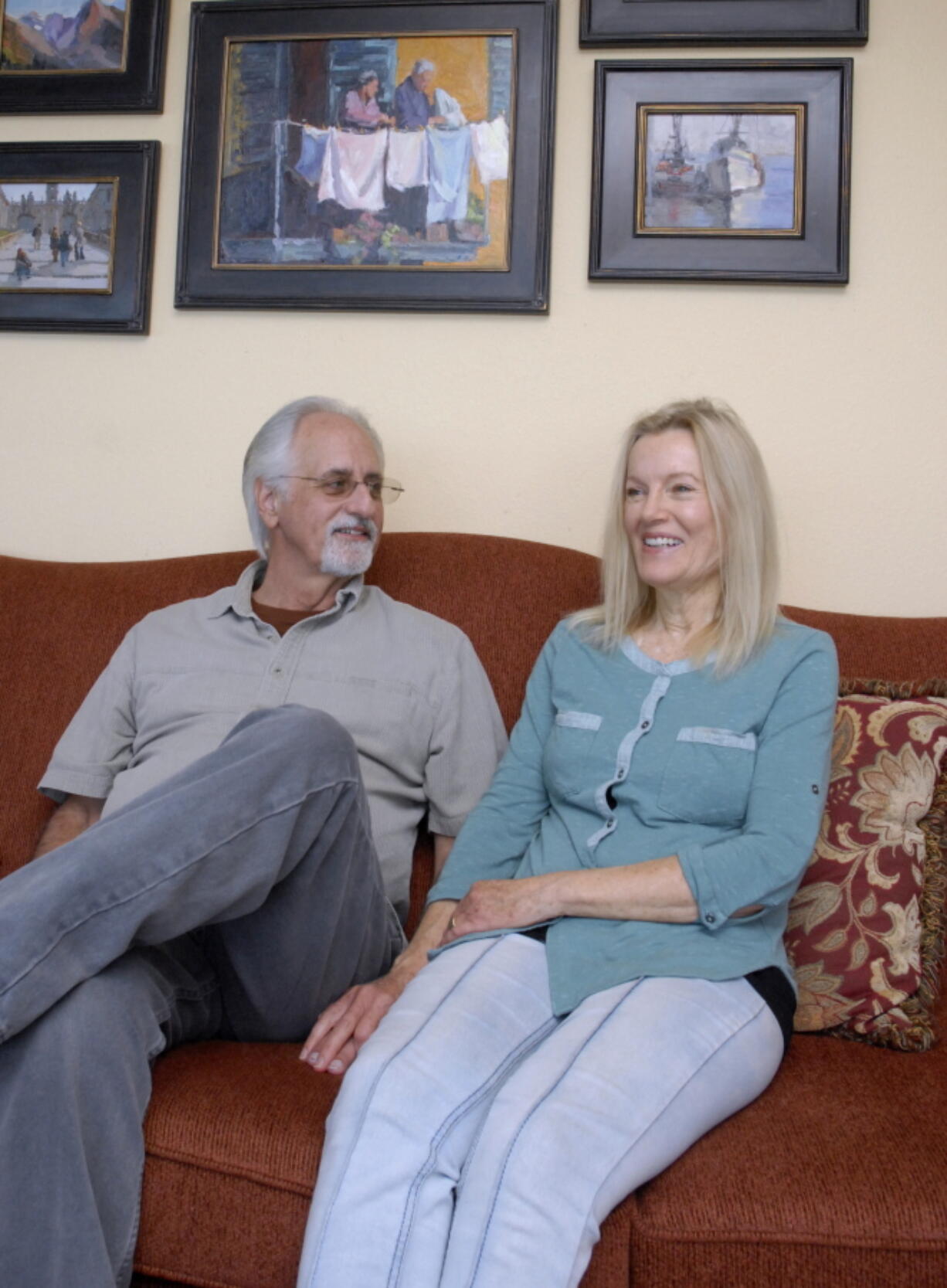 Jeanne Edwards and her husband, Mike, talk April 25 in Port Angeles. Her paintings hang in a church in Kenya to honor the donor who provided a heart for Mike Edwards.