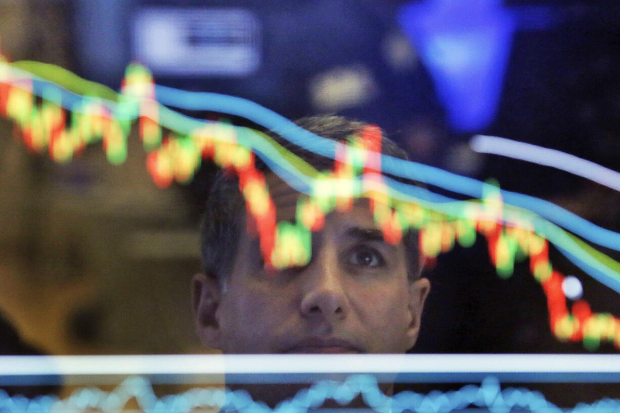 Specialist Anthony Rinaldi is reflected in a screen at his post on the floor of the New York Stock Exchange.