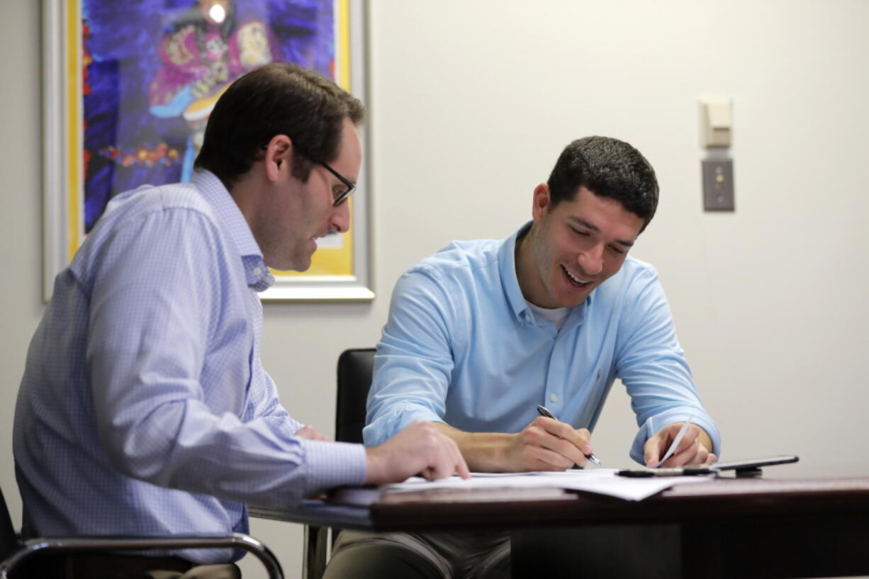 Michael Finkelstein works in his law office with attorney Scott Sternberg in New Orleans on May 18. Finkelstein, a high school student at Benjamin Franklin High School when Hurricane Katrina hit in 2005, was forced to relocate to Austin, Texas, now lives in New Orleans. This Sunday, officials at Franklin are welcoming back the class of 2006 and offering them honorary diplomas as a way to remember a group that was thrown across the country at a time when they should have been worried about homecoming and college applications.