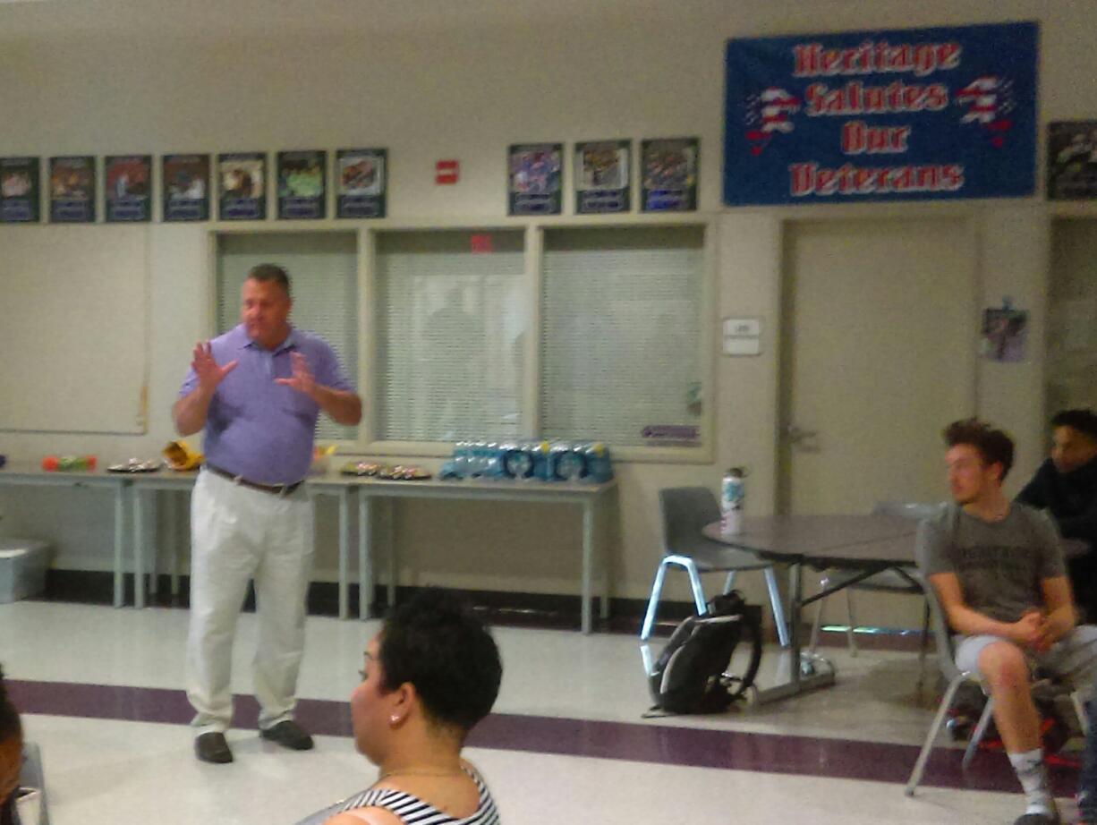 New head basketball coach Brian Childs talks to the players at Heritage High School on Saturday (Tim Martinez/The Columbian)