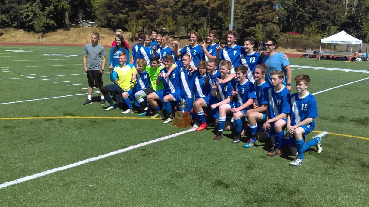 The La Center boys soccer team poses with the 1A district championship trophy after a 2-0 win over Toledo-Winlock (Tim Martinez/The Columbian)