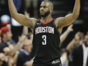 Houston Rockets guard Chris Paul reacts after a 3-pointer by PJ Tucker during the second half in Game 5 of an NBA basketball second-round playoff series against the Utah Jazz, Tuesday, May 8, 2018, in Houston.