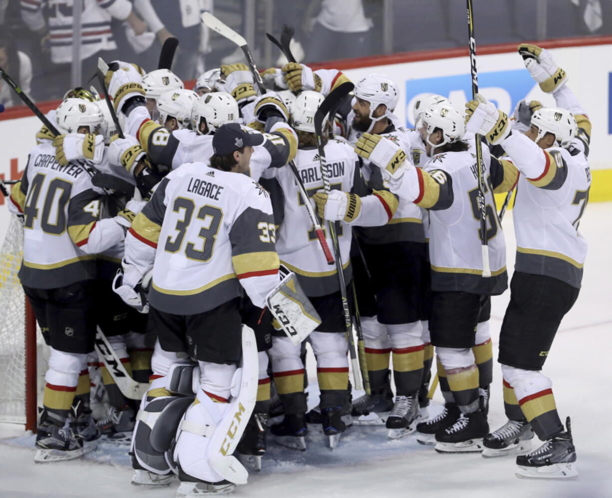 The Vegas Golden Knights mob goaltender Marc-Andre Fleury (29) after defeating the Winnipeg Jets during NHL Western Conference Finals, game 5, in Winnipeg, Sunday, May 20, 2018.