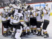 The Vegas Golden Knights mob goaltender Marc-Andre Fleury (29) after defeating the Winnipeg Jets during NHL Western Conference Finals, game 5, in Winnipeg, Sunday, May 20, 2018.