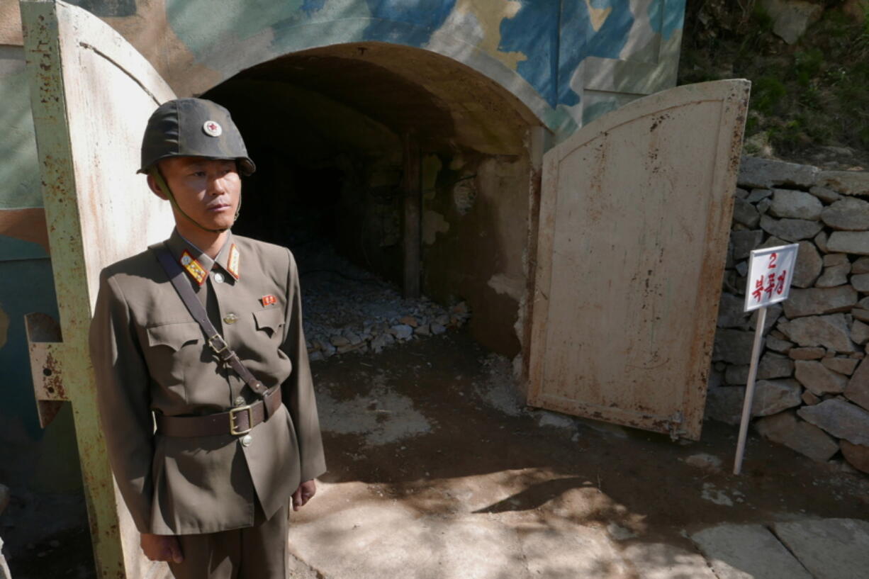 A guard stands at the entrance of the north tunnel at North Korea’s nuclear test site shortly before it was to be blown up in a media tour of dismantling the test site, at Punggye-ri, North Hamgyong Province, North Korea, on Thursday.