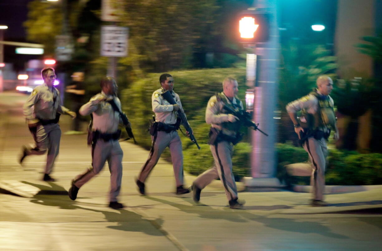 Police run toward the scene of a shooting near the Mandalay Bay resort and casino on the Las Vegas Strip in Las Vegas on Oct. 1. Police in Las Vegas plan to release witness statements and officer reports of the Oct. 1 gunfire that killed 58 people and injured hundreds in the deadliest mass shooting in modern U.S. history. The scheduled release of documents on Wednesday, May 16, 2018, comes more than seven months after the shooting on the Las Vegas Strip.