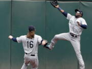 Seattle Mariners center fielder Guillermo Heredia, right, leaps but can’t catch a line drive from Oakland Athletics’ Stephen Piscotty during the first inning of a baseball game Thursday, May 24, 2018, in Oakland, Calif. Piscotty drove in two runs with a double on the play.