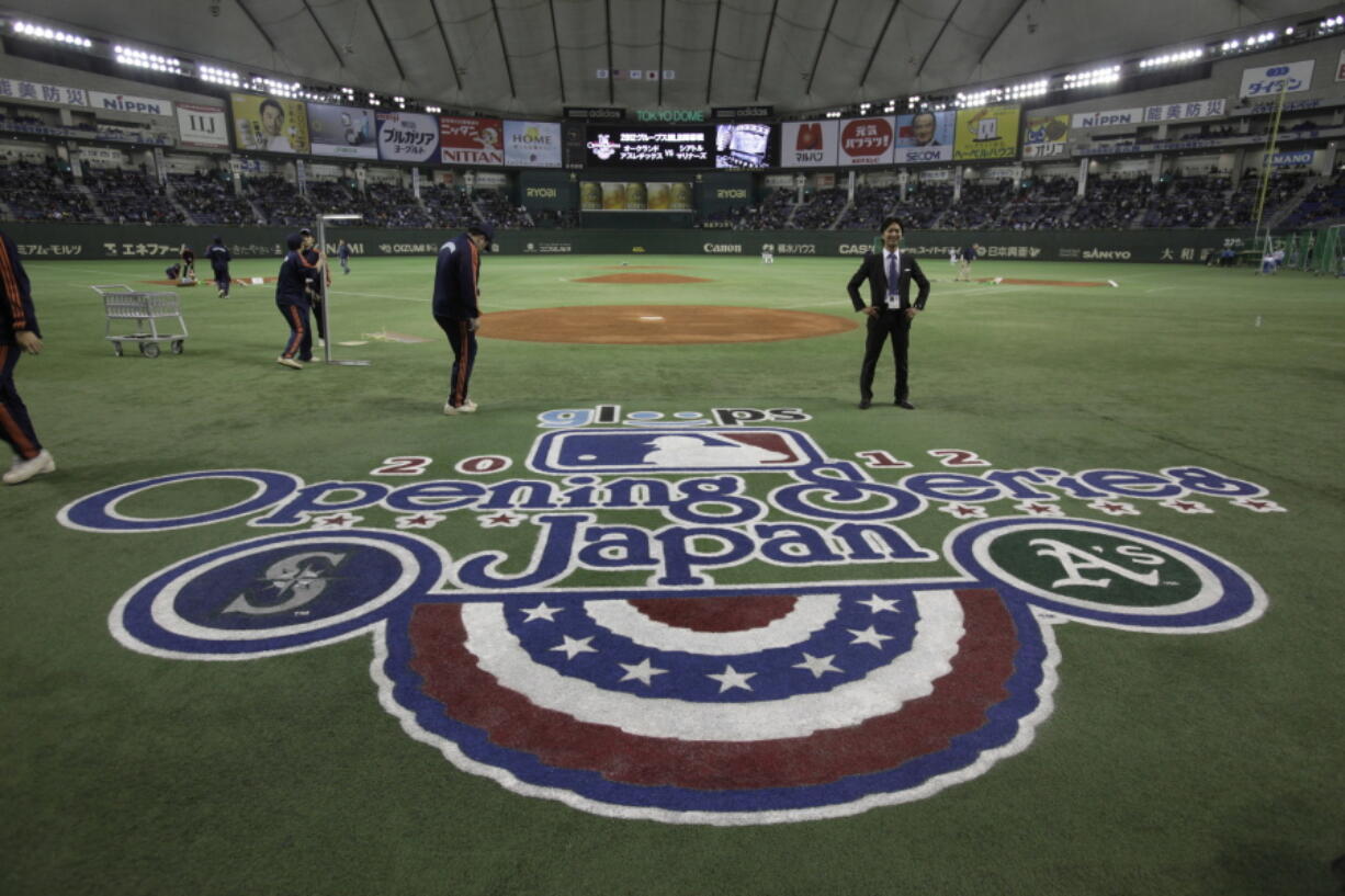 Ground staff work prior to the 2012 Major League Baseball game between the Oakland Athletics and the Seattle Mariners at Tokyo Dome in Tokyo. Oakland and Seattle will play an opening two-game series in Tokyo on March 20 and 21, the fifth time Major League Baseball will start its season in Japan. Oakland will be the home team for both games, Major League Baseball said Tuesday, May 1, 2018.