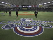 Ground staff work prior to the 2012 Major League Baseball game between the Oakland Athletics and the Seattle Mariners at Tokyo Dome in Tokyo. Oakland and Seattle will play an opening two-game series in Tokyo on March 20 and 21, the fifth time Major League Baseball will start its season in Japan. Oakland will be the home team for both games, Major League Baseball said Tuesday, May 1, 2018.