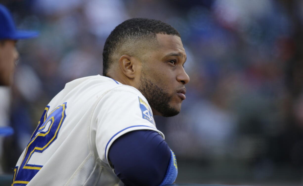 Seattle Mariners’ Robinson Cano watches from the dugout during a baseball game against the Cleveland Indians in Seattle. Cano has been suspended 80 games for violating baseball’s joint drug agreement, the league announced Tuesday, May 15, 2018. (AP Photo/Ted S.