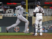 Seattle Mariners’ Dee Gordon, left, scores past Minnesota Twins catcher Mitch Garver on a sacrifice bunt by Jean Segura and a throwing error in the eighth inning of a makeup baseball game, Monday, May 14, 2018, in Minneapolis. The Mariners won 1-0.