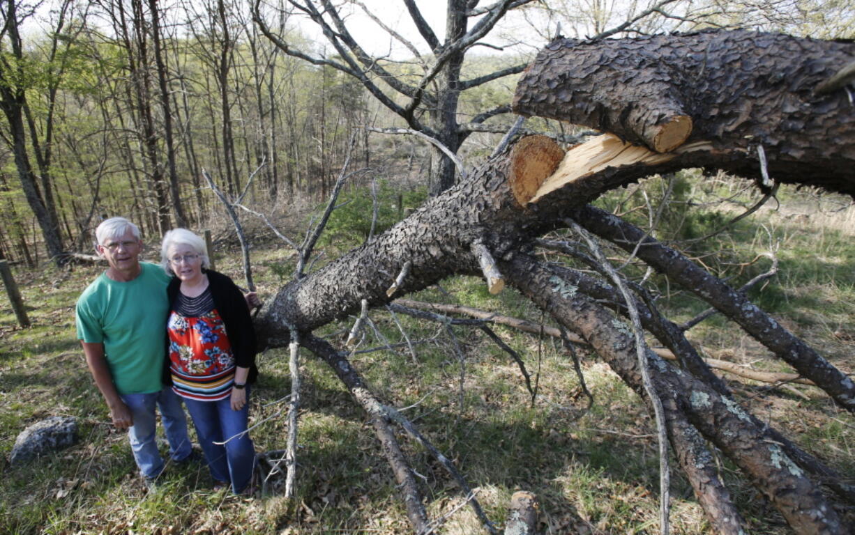 Becky and Roger Crabtree pose May 3 next to a downed tree on the route of the proposed Mountain Valley Pipeline on their property in Lindside, W.Va. The Crabtree’s are part of a coalition of Virginia and West Virginia landowners opposed to what they call an unconstitutional land grab and have taken their fight to a federal appeals court.