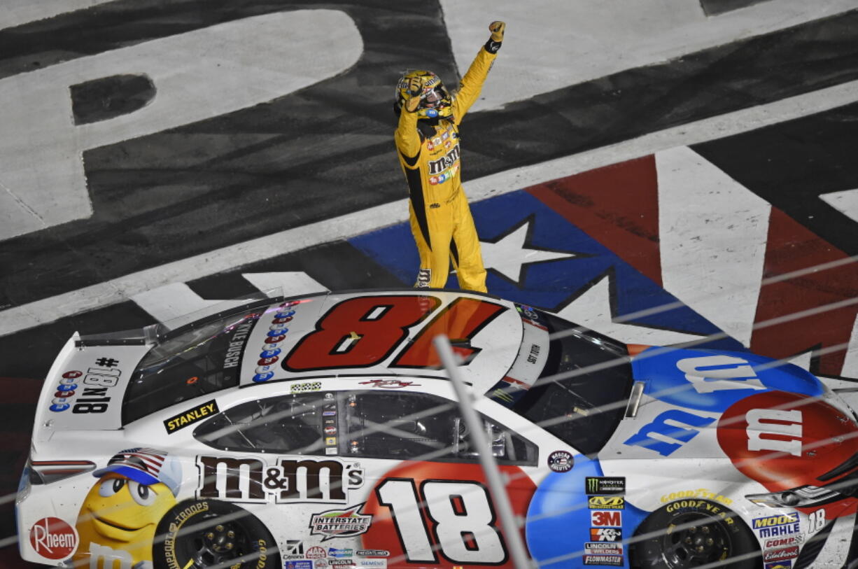 Kyle Busch celebrates after winning the NASCAR Cup Series auto race at Charlotte Motor Speedway in Charlotte, N.C., Sunday, May 27, 2018.