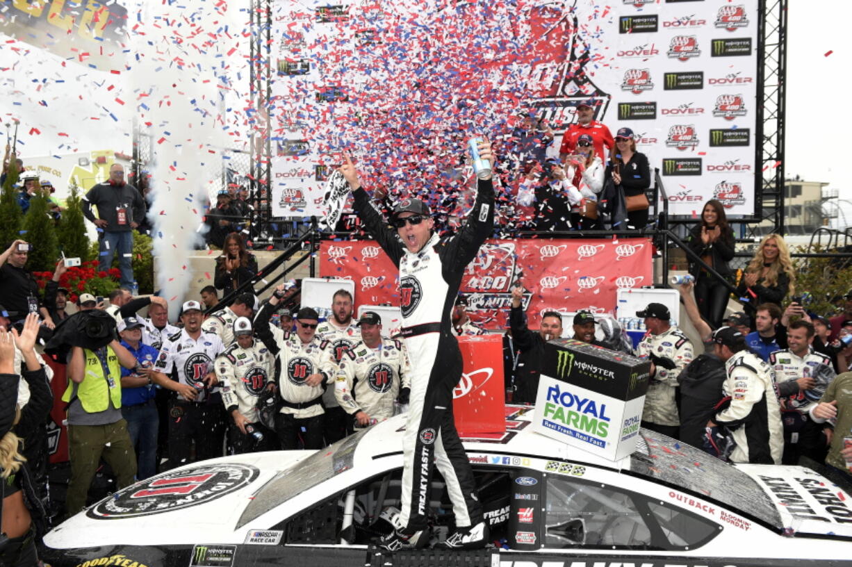 Kevin Harvick, center, celebrates in Victory Lane after he won the NASCAR Cup Series auto race, Sunday, May 6, 2018, at Dover International Speedway in Dover, Del.