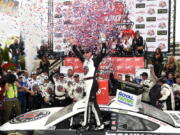 Kevin Harvick, center, celebrates in Victory Lane after he won the NASCAR Cup Series auto race, Sunday, May 6, 2018, at Dover International Speedway in Dover, Del.