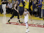 Golden State Warriors guard Stephen Curry (30) celebrates in front of Cleveland Cavaliers forward Kevin Love during overtime of Game 1 of basketball's NBA Finals in Oakland, Calif., Thursday, May 31, 2018.