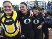 Oregon catcher Gwen Svelos, pitcher Miranda Elish, Lauren Lindvall and Jenna Lilley, from left, celebrate the team’s win over Kentucky in an NCAA softball tournament super regional, Saturday, May 26, 2018, in Eugene, Ore.