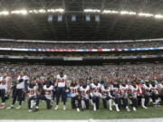 Houston Texans players kneel and stand during the singing of the national anthem before an NFL football game against the Seattle Seahawks, in Seattle. NFL owners have approved a new policy aimed at addressing the firestorm over national anthem protests, permitting players to stay in the locker room during the “The Star-Spangled Banner” but requiring them to stand if they come to the field. The decision was announced Wednesday, May 23, 2018, by NFL Commissioner Roger Goodell during the league’s spring meeting in Atlanta.