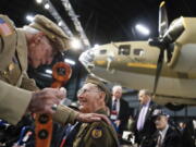 Veterans gather for a private viewing of the Memphis Belle, a Boeing B-17 “Flying Fortress,” at the National Museum of the U.S. Air Force, Wednesday, May 16, 2018, in Dayton, Ohio. The World War II bomber Memphis Belle is set to go on display for the first time since getting a yearslong restoration at the museum. The B-17 “Flying Fortress” will be introduced Thursday morning as the anchor of an extensive exhibit in the Dayton-area museum’s World War II gallery.