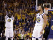 Golden State Warriors' Draymond Green, left, raises his arms in celebration after a 3-point basket by teammate Stephen Curry (30) during the second half in Game 5 of an NBA basketball second-round playoff series against the New Orleans Pelicans Tuesday, May 8, 2018, in Oakland, Calif.